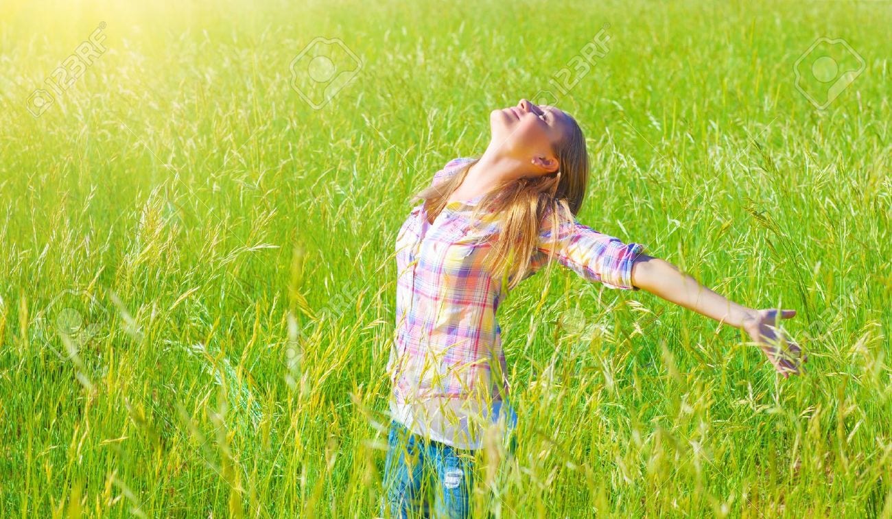 18522017-Woman-having-fun-outdoor-enjoying-fresh-air-and-spring-green-grass-freedom-and-happiness-concept-Stock-Photo
